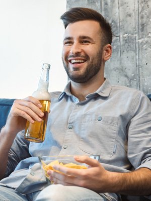 Men eat snacks and drink beer