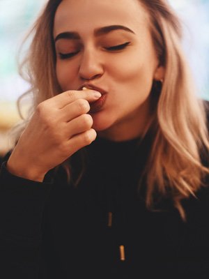 Girl eats a Baked Extruded Snack